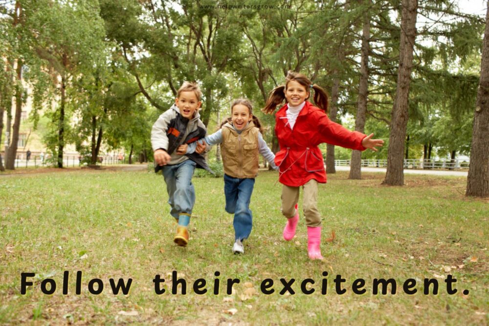 Three children running together outdoors among colorful fall leaves